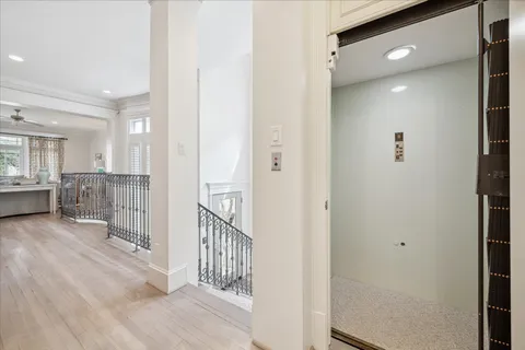 a view of a hallway with wooden floor and windows