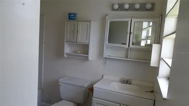 a bathroom with a toilet and a sink