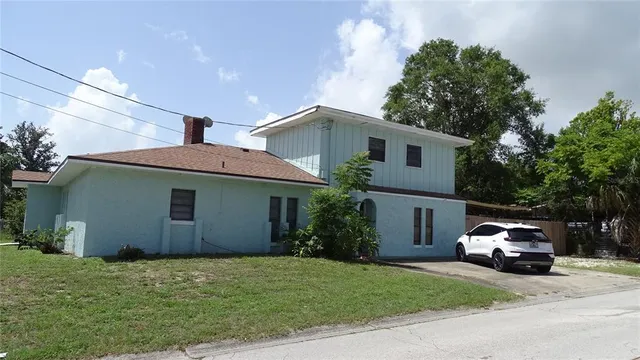 a house with a truck parked in front of a house