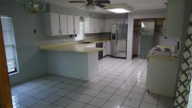 a kitchen with a sink cabinets and appliances