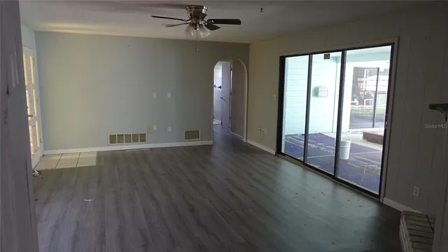wooden floor in an empty room with a window