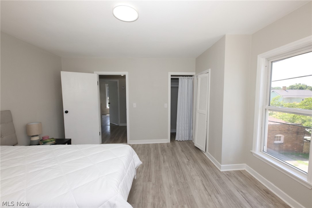 416 5th Street Chester, WV 26034 - Photo 18 of 24 Bedroom featuring wood-finish flooring, neutral wall tones, and a window with white trim