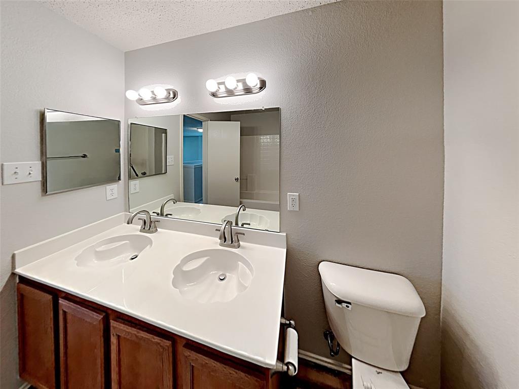 2104 Navada Way Fort Worth, TX 76247 - Photo 12 of 19 a bathroom with a sink mirror and toilet