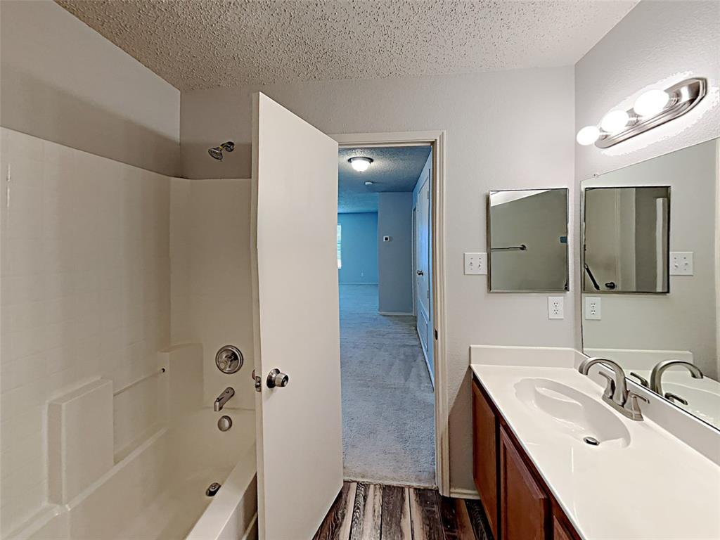 2104 Navada Way Fort Worth, TX 76247 - Photo 13 of 19 a bathroom with a sink a toilet and shower