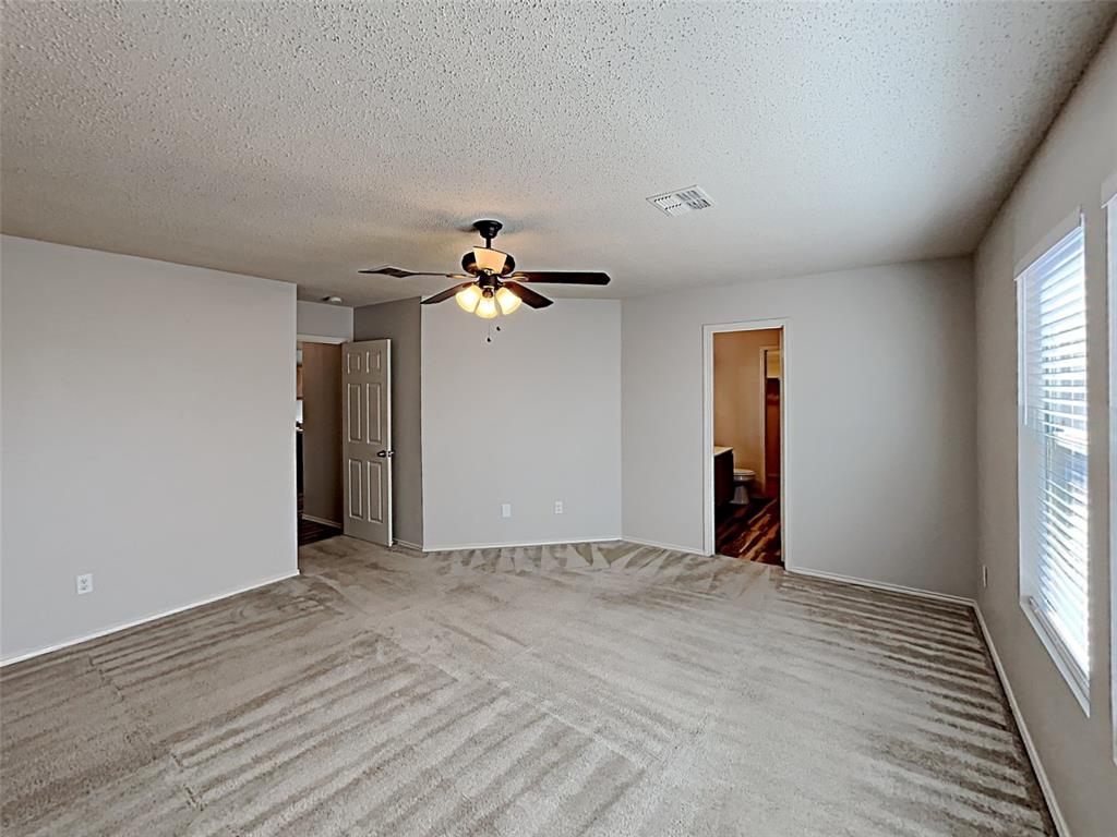 2104 Navada Way Fort Worth, TX 76247 - Photo 16 of 19 a view of an empty room with window and wooden floor