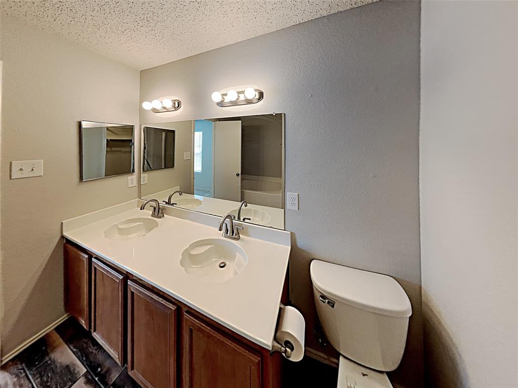 2104 Navada Way Fort Worth, TX 76247 - Photo 17 of 19 a bathroom with a sink mirror and toilet