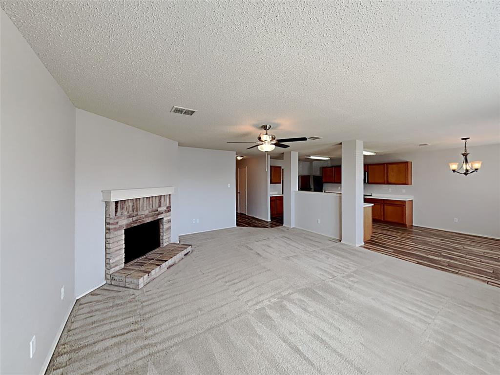 2104 Navada Way Fort Worth, TX 76247 - Photo 2 of 19 a view of a livingroom with a fireplace and window