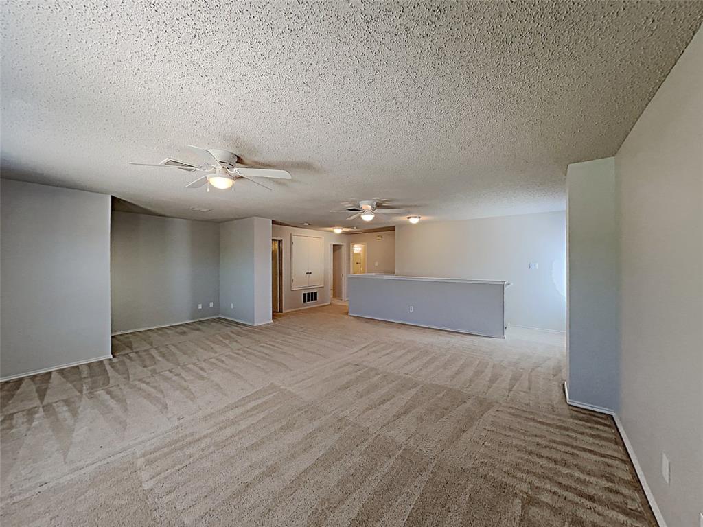 2104 Navada Way Fort Worth, TX 76247 - Photo 6 of 19 a view of a big room with wooden floor and chandelier