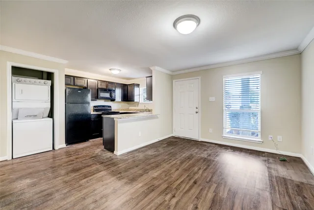 a view of kitchen with wooden floor electronic appliances and window