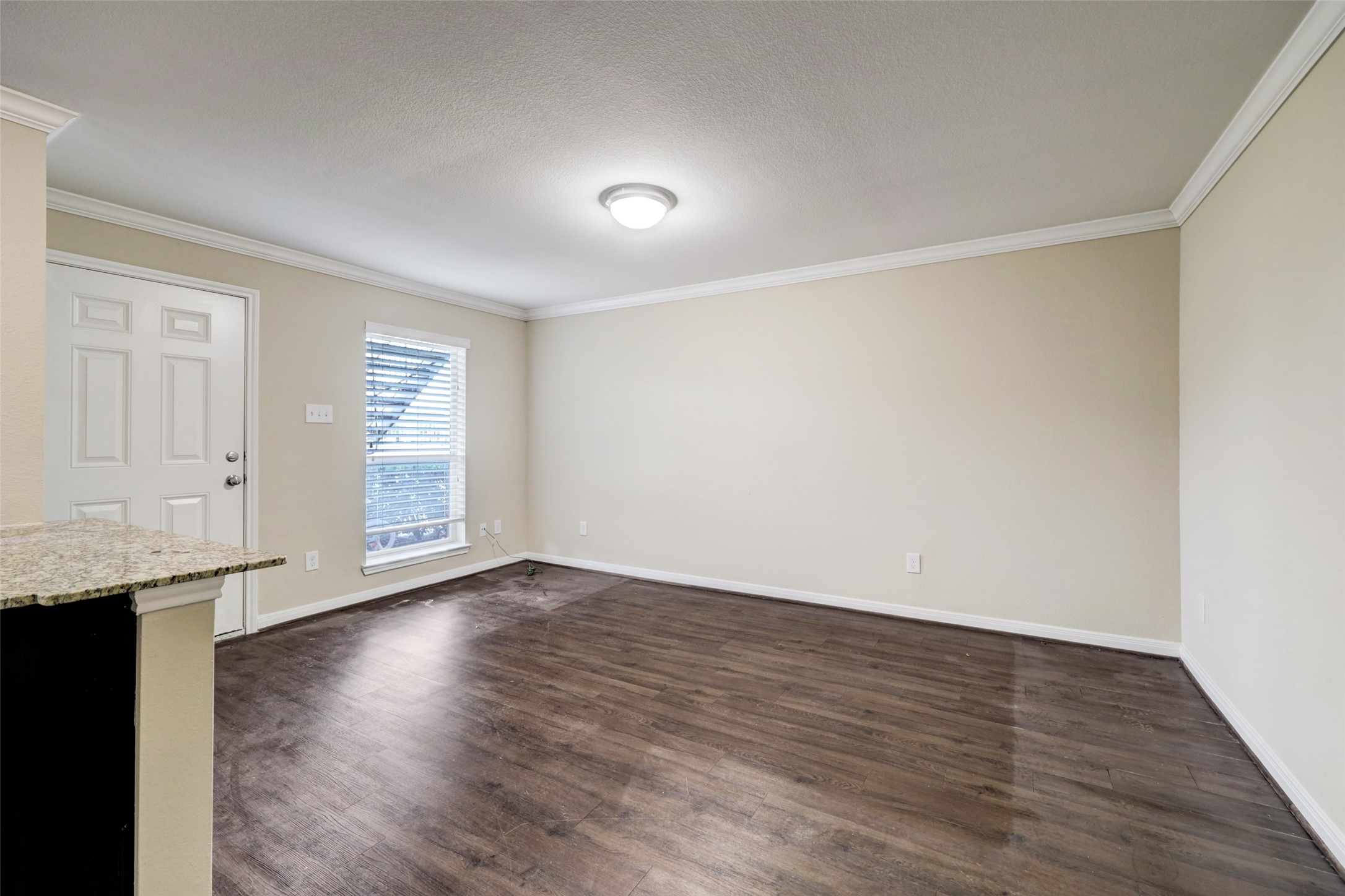 1600 West T C Jester Boulevard, Unit 94 Houston, TX 77008 - Photo 3 of 10 an empty room with wooden floor and windows