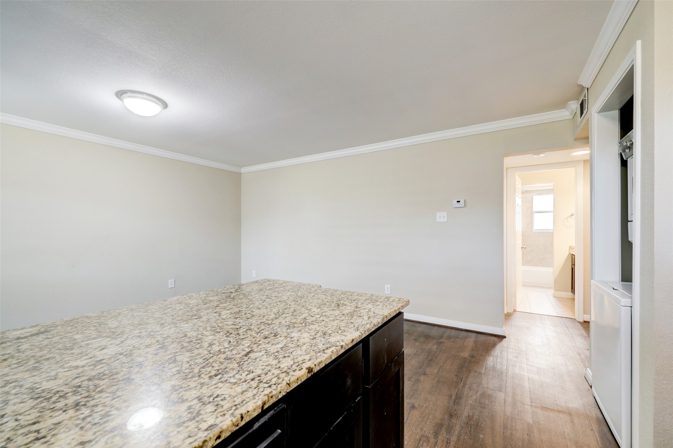1600 West T C Jester Boulevard, Unit 94 Houston, TX 77008 - Photo 5 of 10 a view of kitchen island with wooden floor