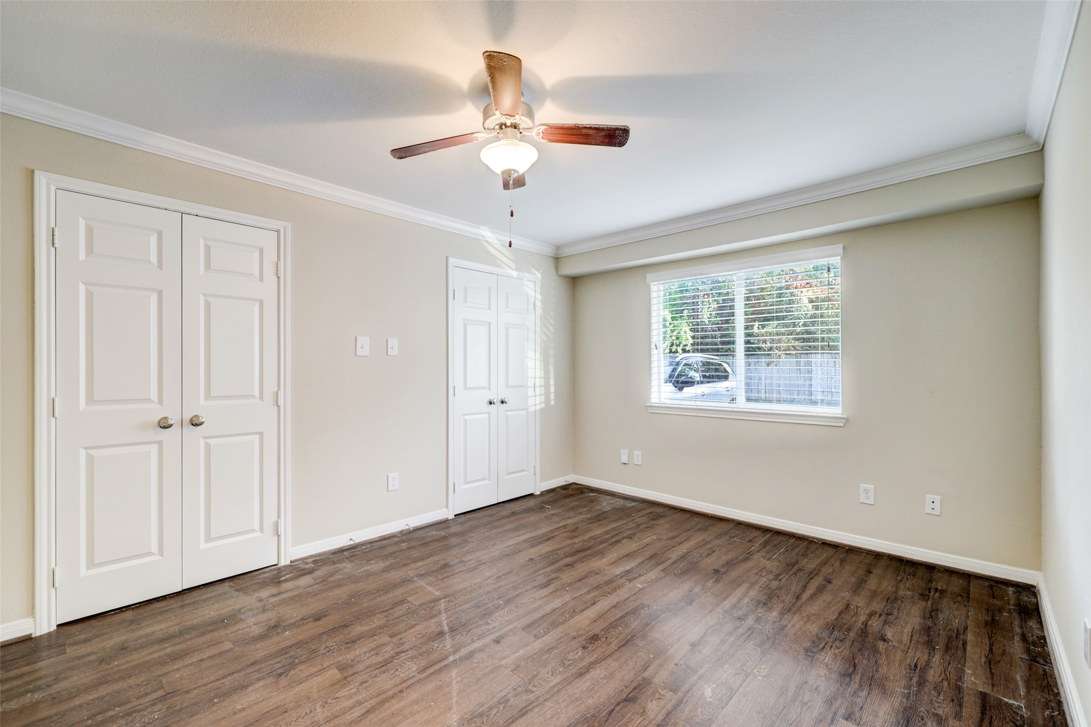 1600 West T C Jester Boulevard, Unit 94 Houston, TX 77008 - Photo 6 of 10 a view of an empty room with wooden floor and a window