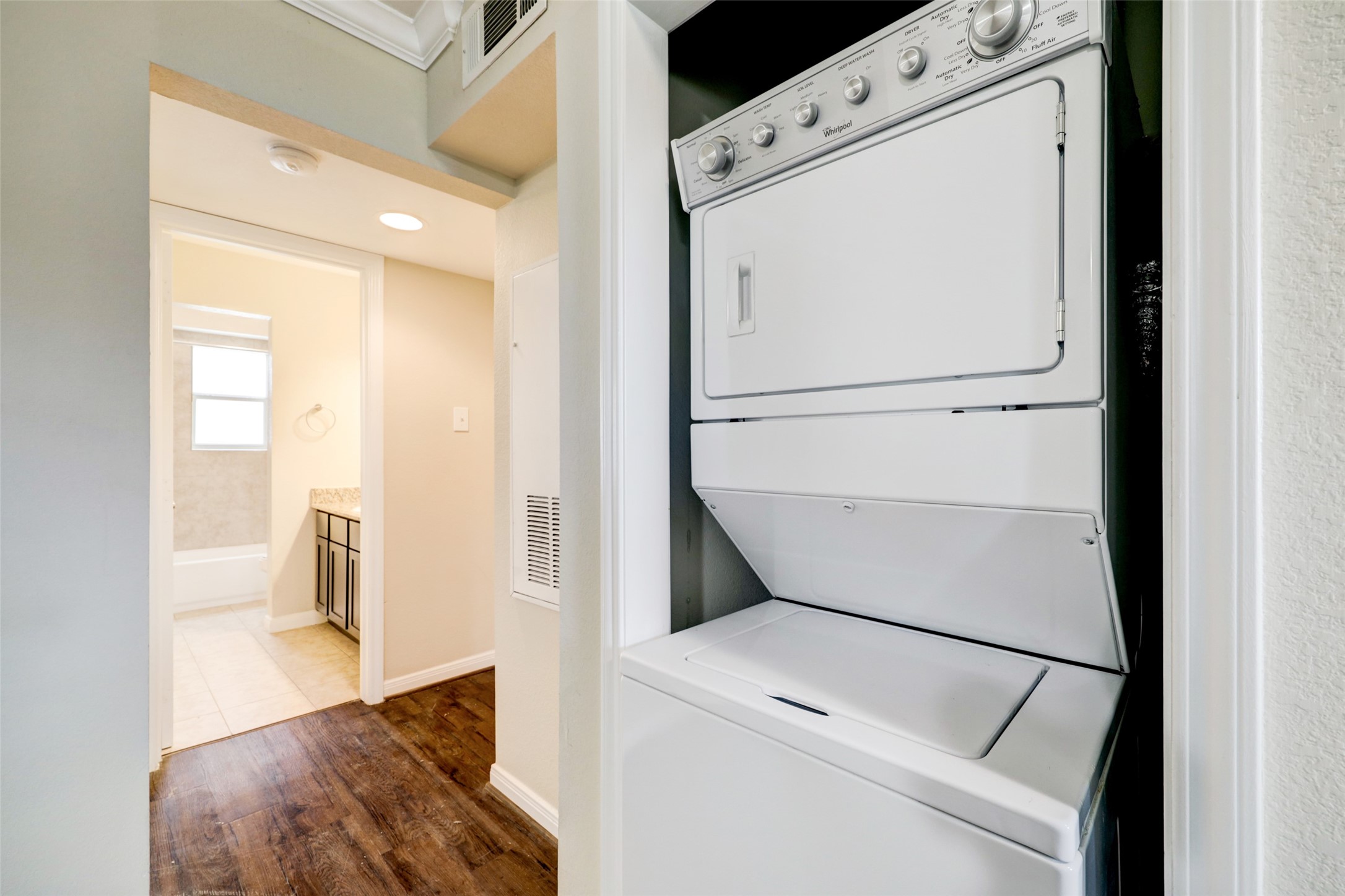 1600 West T C Jester Boulevard, Unit 94 Houston, TX 77008 - Photo 9 of 10 a view of washer and dryer with wooden floor