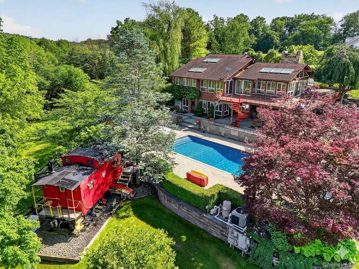 165 Hasbrouck Road Goshen, NY 10924 - Photo 14 of 50 The expansive pool deck features a salt water pool, koi pond, hot tub, fire pit, outdoor cook area and a caboose!