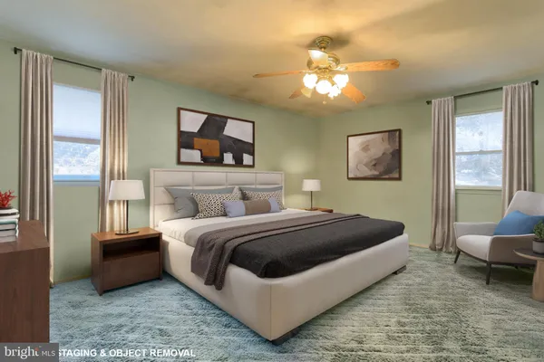 a spacious bedroom with a bed a couch and a chandelier