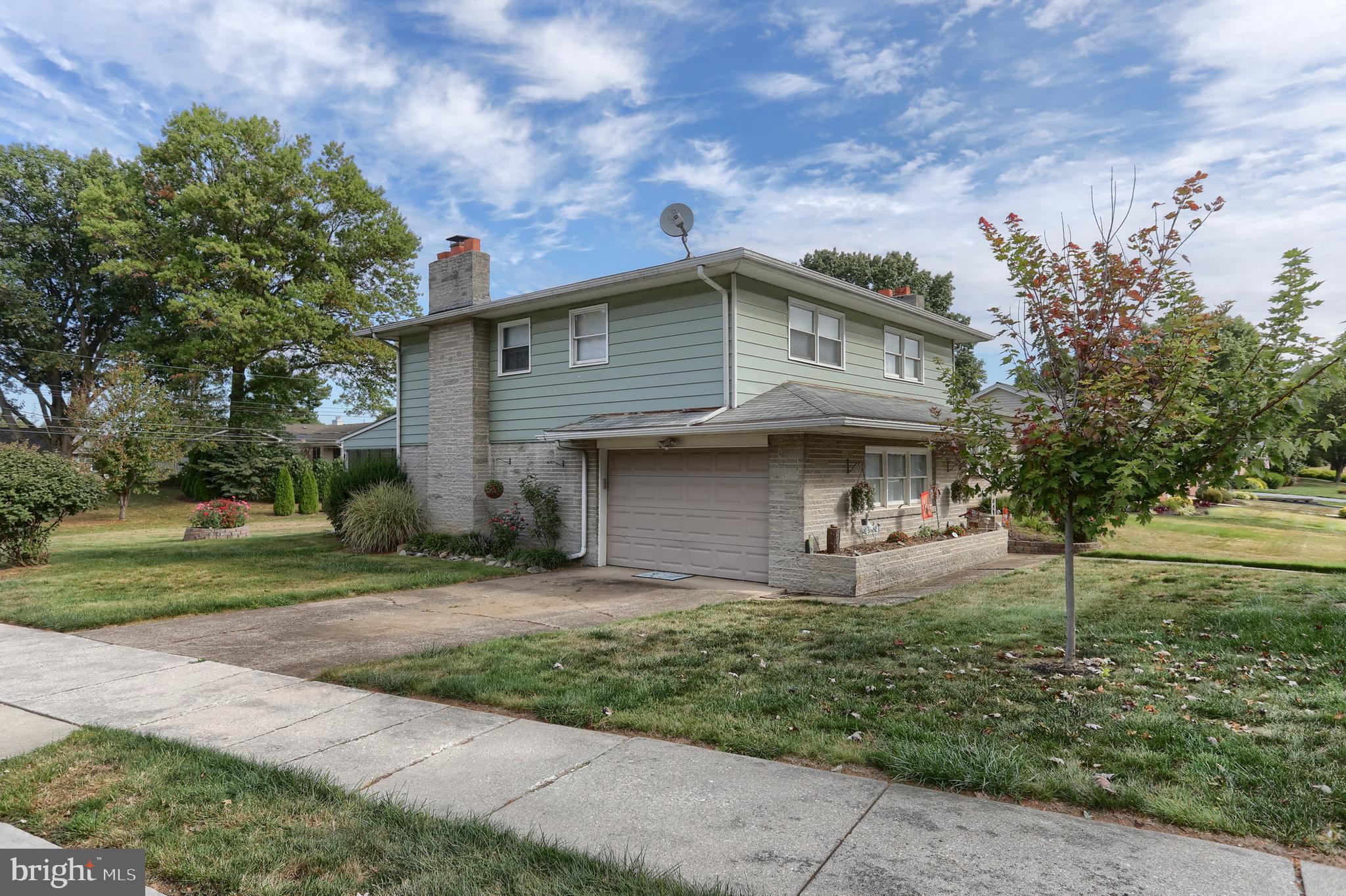 81 Locust Avenue Hershey, PA 17033 - Photo 13 of 18 a front view of a house with a garden