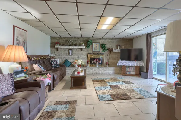 a living room with furniture and a chandelier