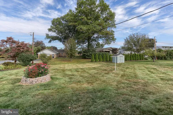 a backyard of a house with a table and chairs