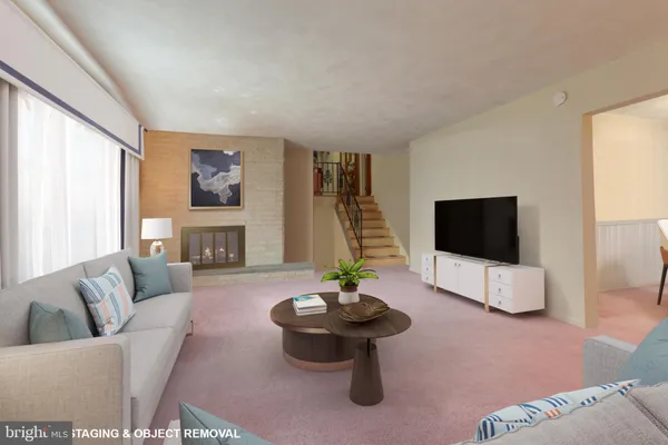 a living room with furniture a flat screen tv and a large window