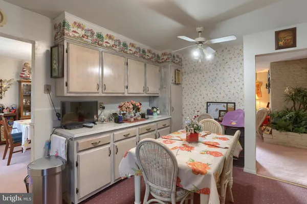 a kitchen with a table chairs stove and cabinets