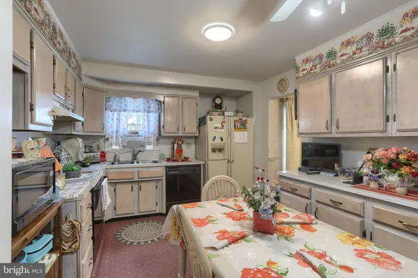 a kitchen with stainless steel appliances kitchen island granite countertop a sink dishwasher stove and cabinets