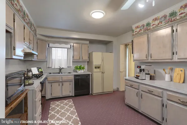 a kitchen with a sink stove and refrigerator
