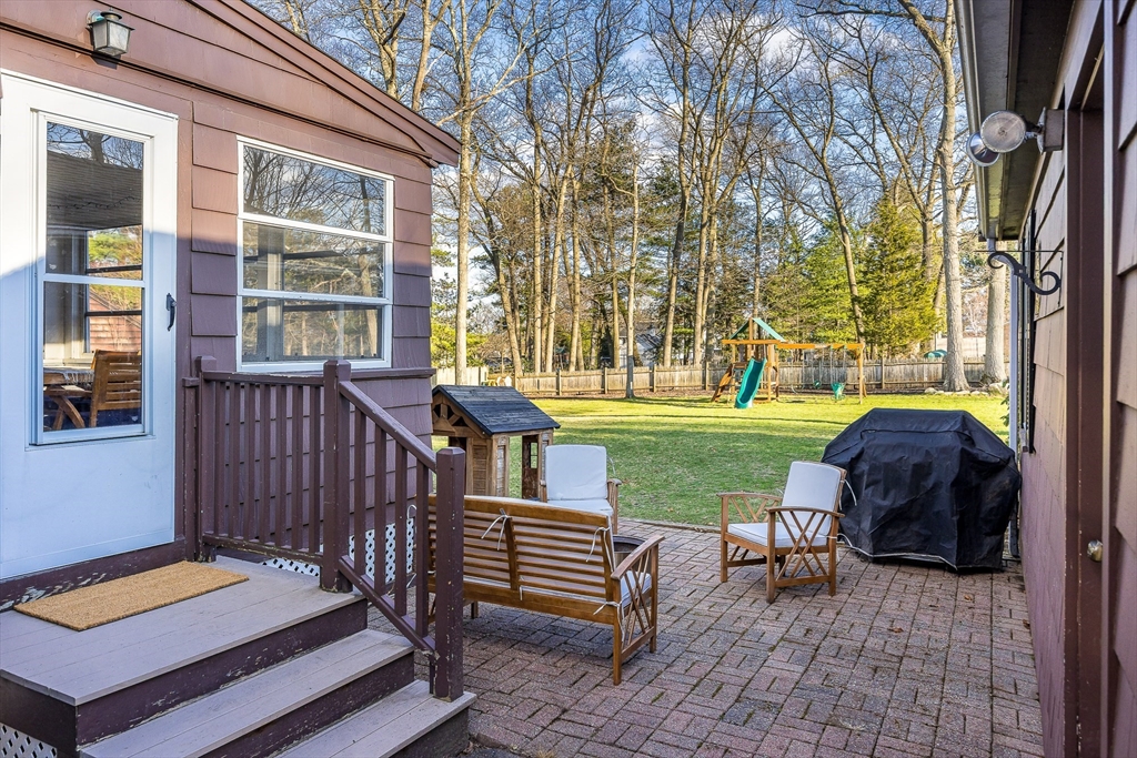 55 Lothrop Road Reading, MA 01867 - Photo 40 of 41 a view of a patio with chairs and a yard