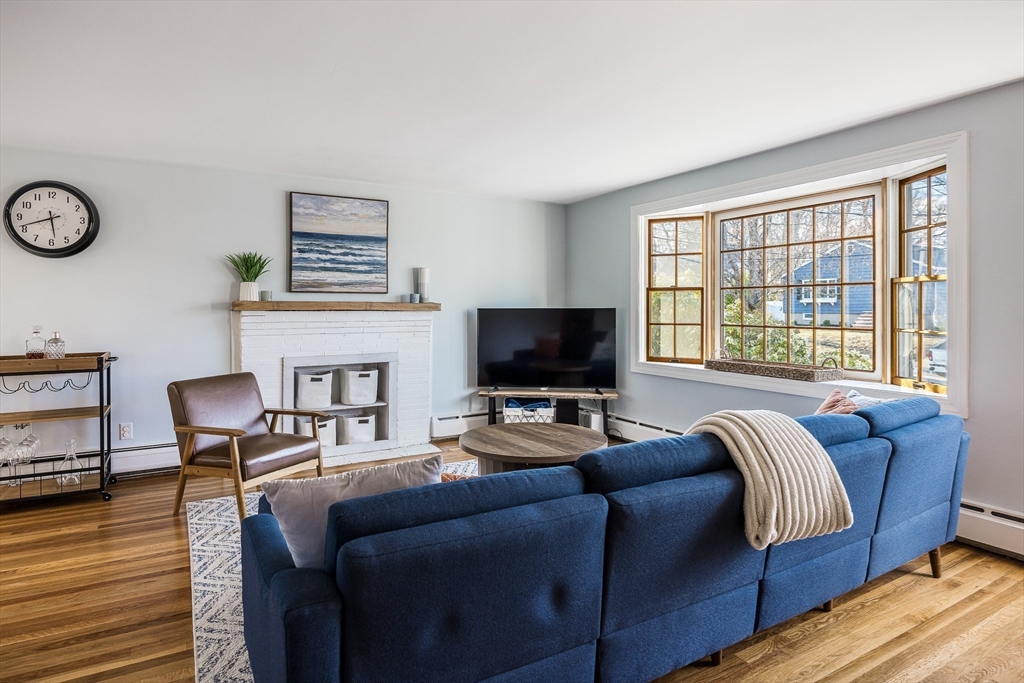 55 Lothrop Road Reading, MA 01867 - Photo 5 of 41 a living room with furniture a flat screen tv and a large window
