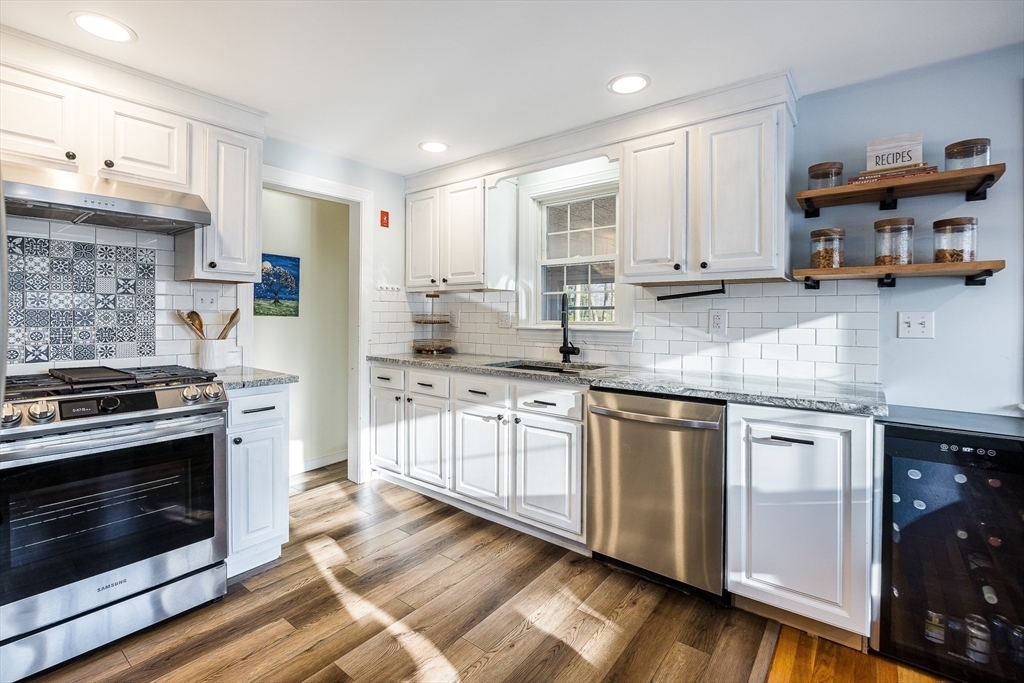 55 Lothrop Road Reading, MA 01867 - Photo 10 of 41 a kitchen with stainless steel appliances granite countertop a stove a sink and a refrigerator