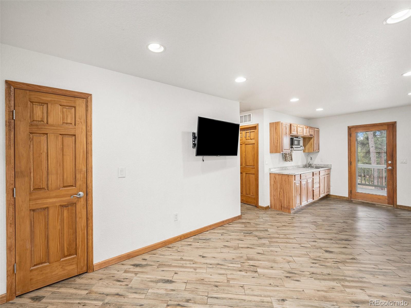 11748 Apache Trail Conifer, CO 80433 - Photo 20 of 34 a view of a kitchen with wooden floor and electronic appliances