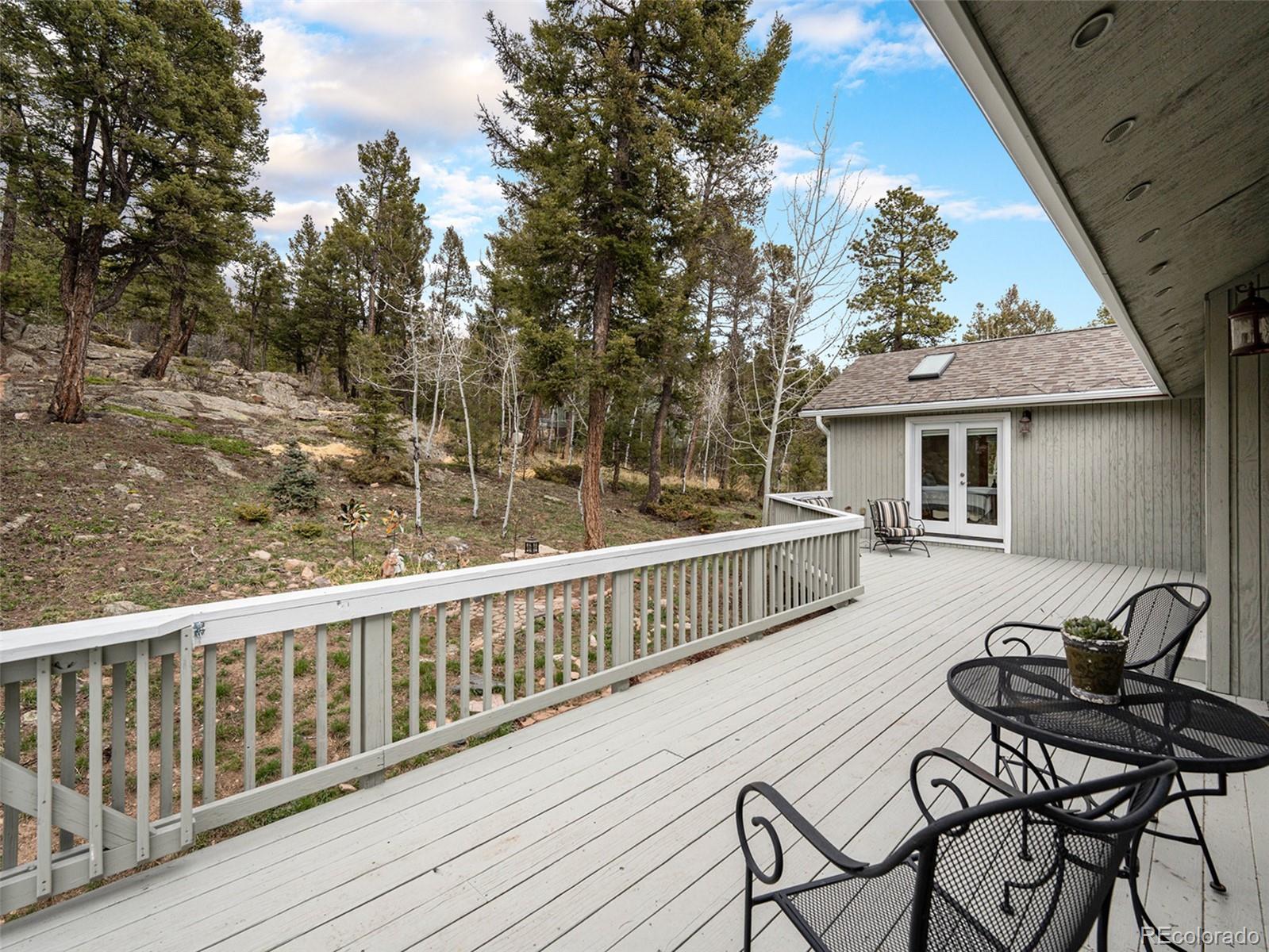 11748 Apache Trail Conifer, CO 80433 - Photo 2 of 34 a view of a chair and table on the deck