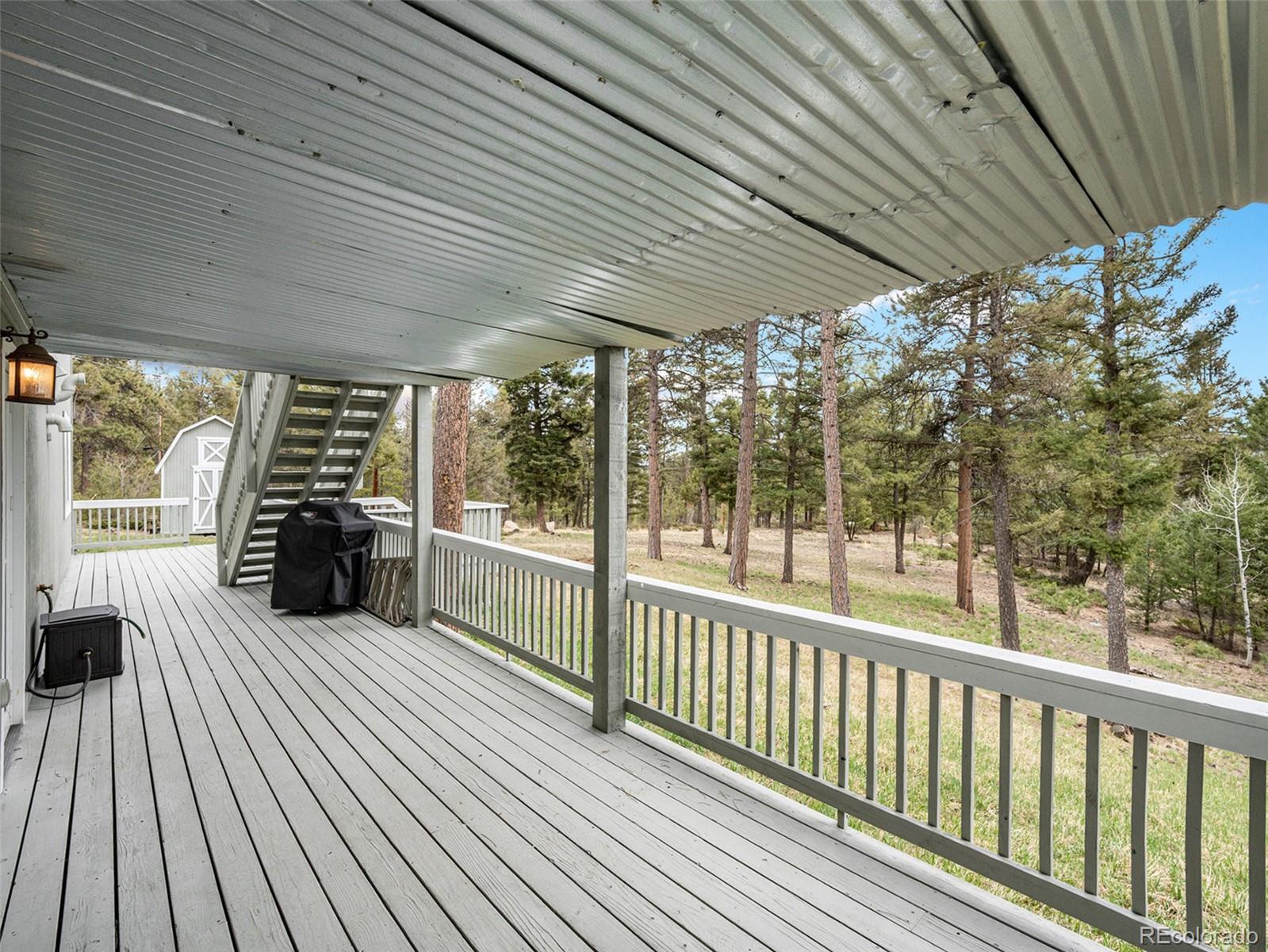 11748 Apache Trail Conifer, CO 80433 - Photo 22 of 34 a view of a porch with wooden floor