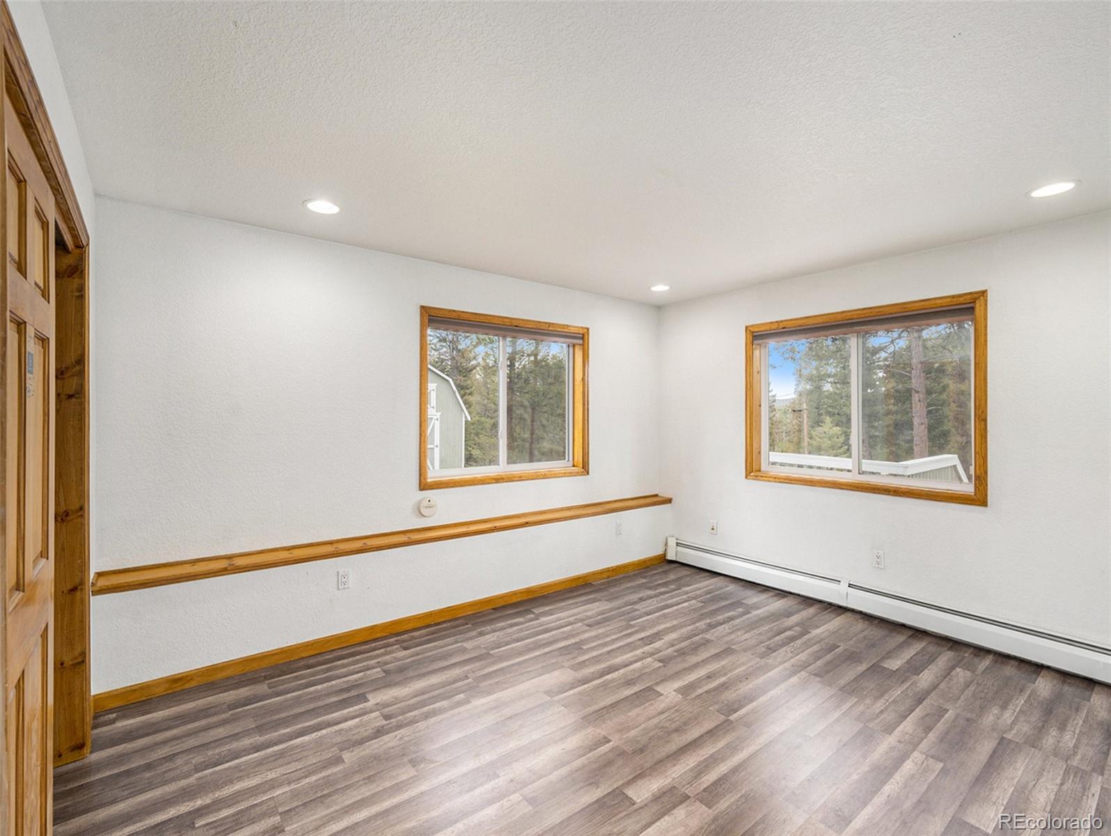 11748 Apache Trail Conifer, CO 80433 - Photo 24 of 34 a view of an empty room with wooden floor and a window