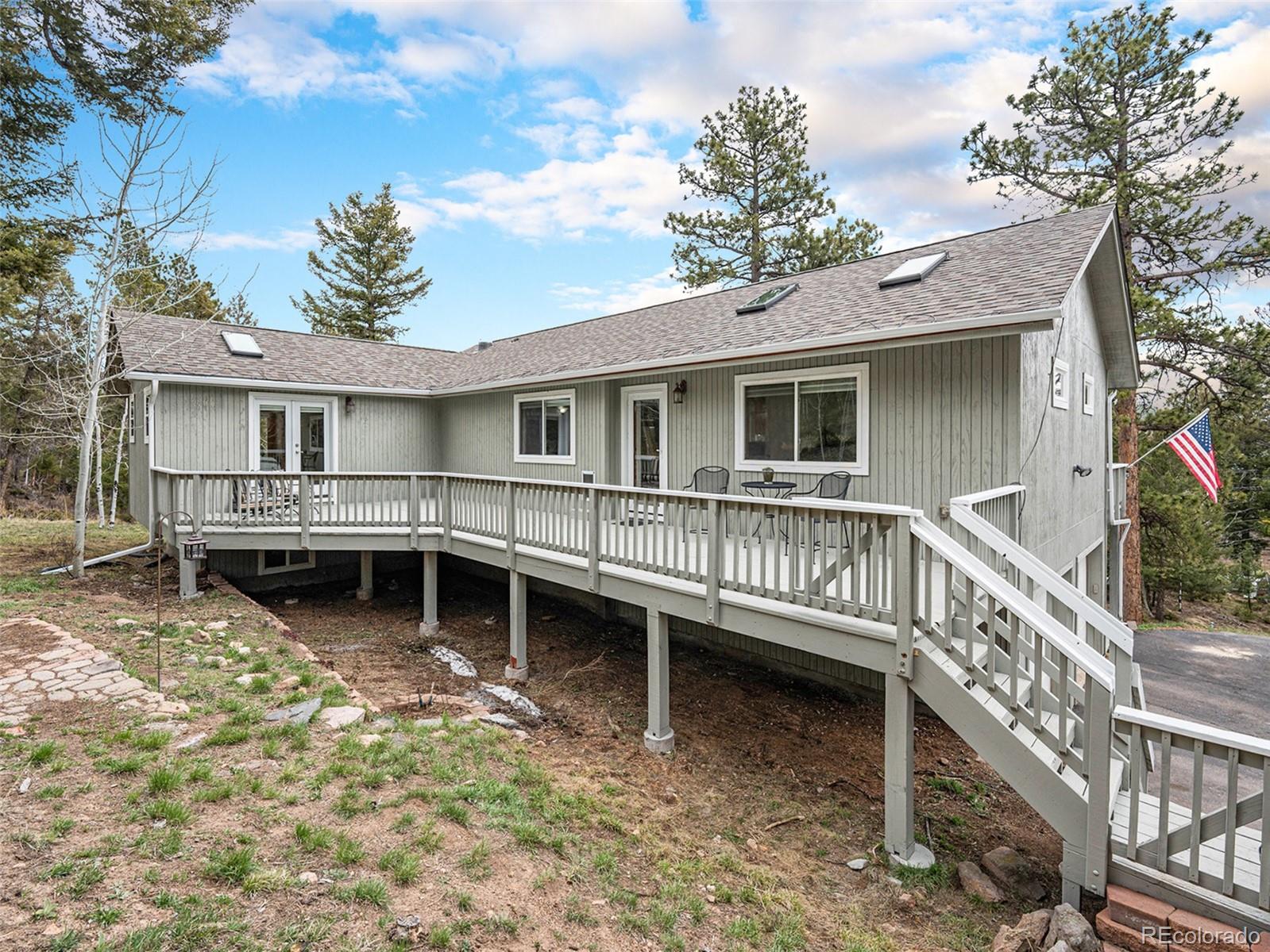 11748 Apache Trail Conifer, CO 80433 - Photo 27 of 34 a view of a house with a roof deck