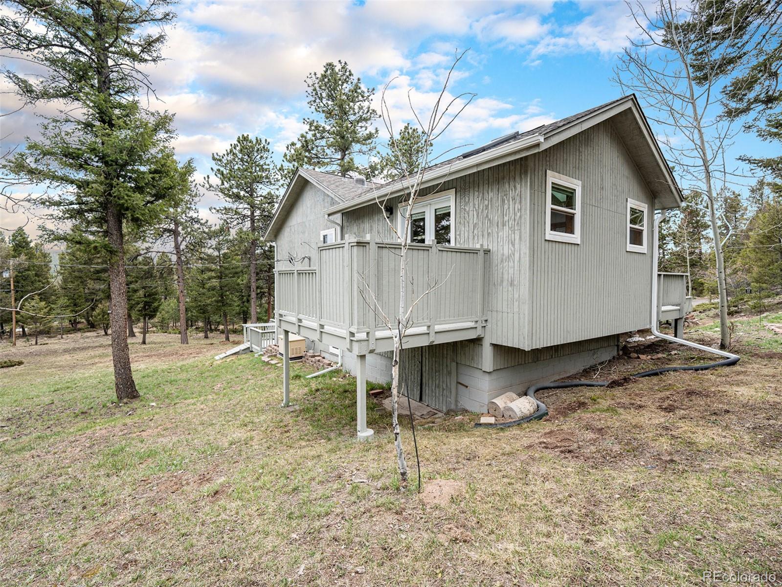 11748 Apache Trail Conifer, CO 80433 - Photo 28 of 34 a backyard of a house with table and chairs