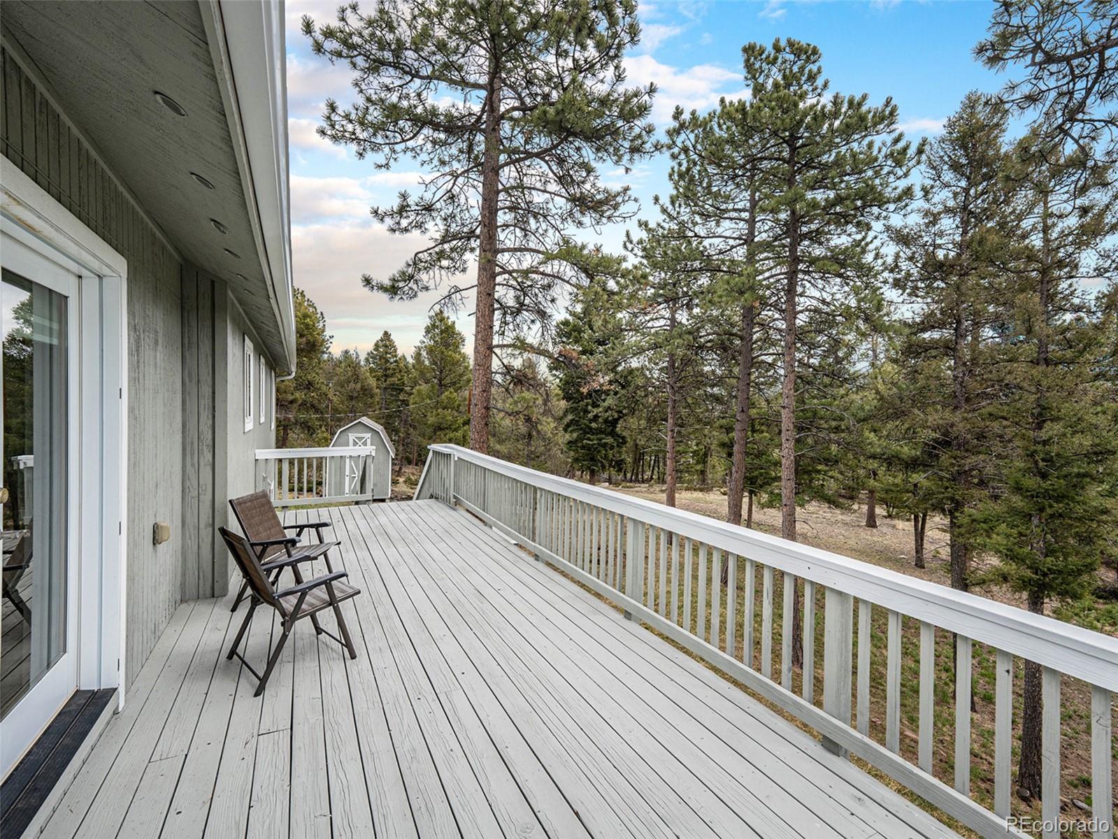 11748 Apache Trail Conifer, CO 80433 - Photo 31 of 34 a view of balcony with deck and wooden floor