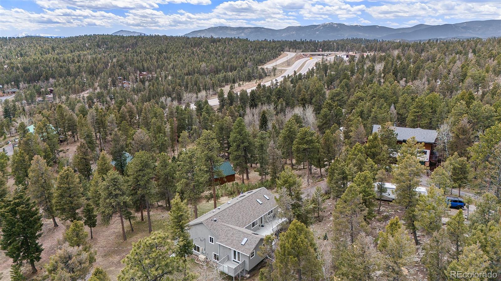 11748 Apache Trail Conifer, CO 80433 - Photo 34 of 34 an aerial view of residential houses with outdoor space and trees