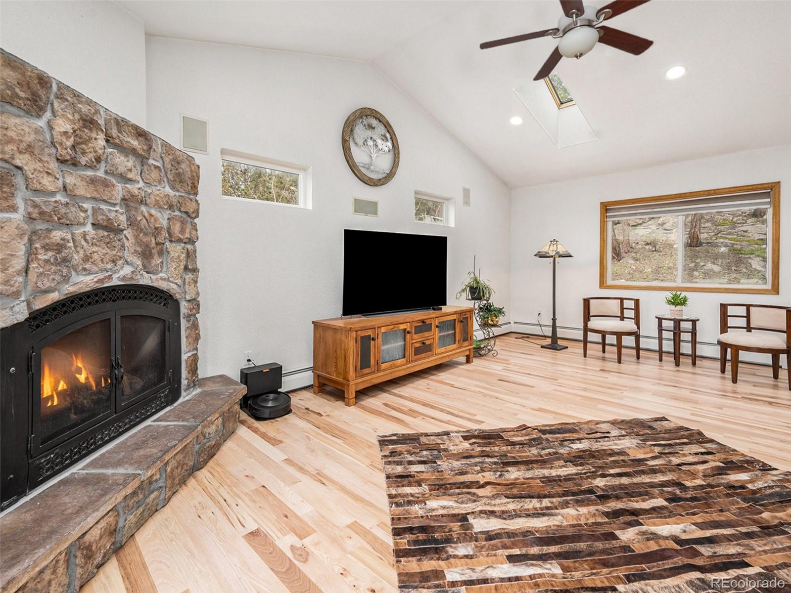 11748 Apache Trail Conifer, CO 80433 - Photo 5 of 34 a living room with furniture and a flat screen tv