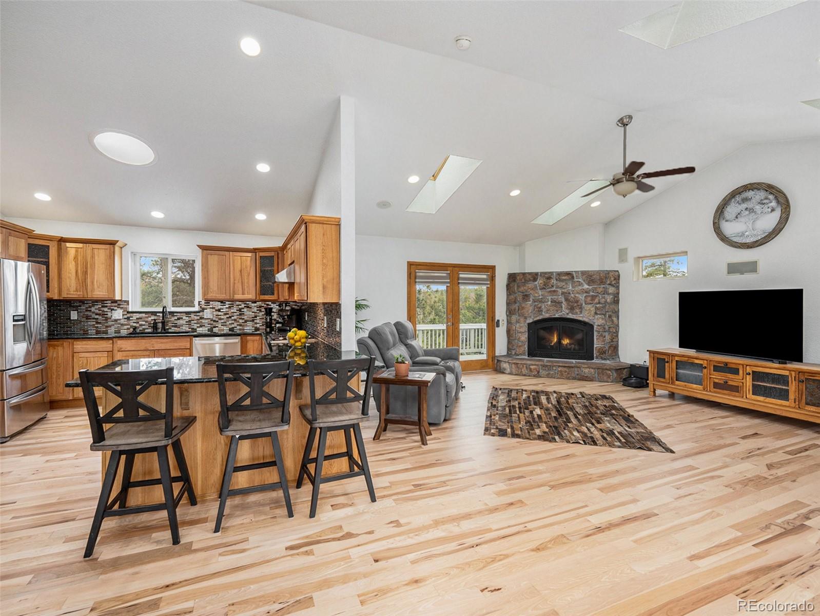 11748 Apache Trail Conifer, CO 80433 - Photo 6 of 34 a living room with furniture a flat screen tv and a fireplace
