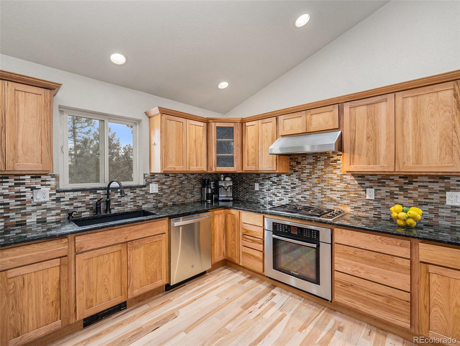 11748 Apache Trail Conifer, CO 80433 - Photo 7 of 34 a kitchen with stainless steel appliances granite countertop a sink and cabinets