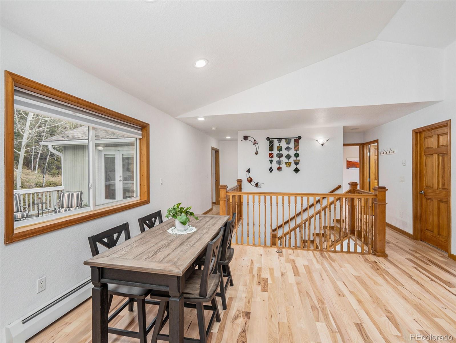 11748 Apache Trail Conifer, CO 80433 - Photo 9 of 34 a view of a dining room with furniture window and wooden floor