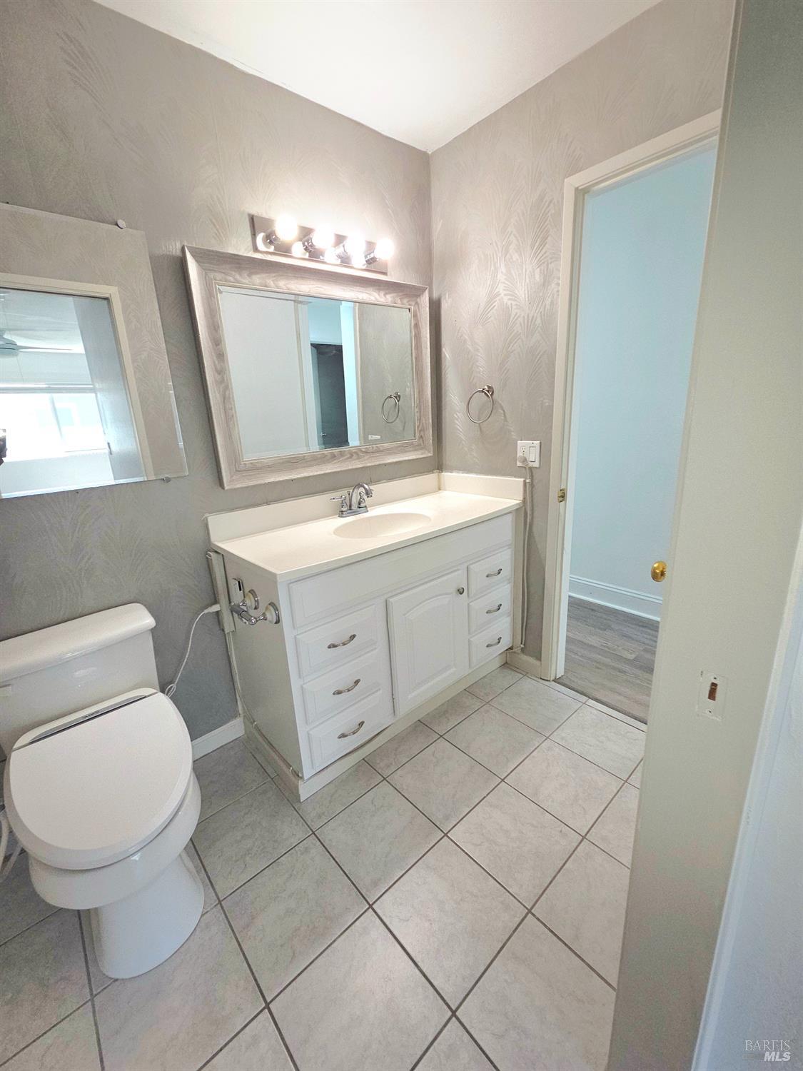 140 Del Rio Court, Unit 4 Vacaville, CA 95687 - Photo 17 of 25 a spacious bathroom with a toilet sink and mirror
