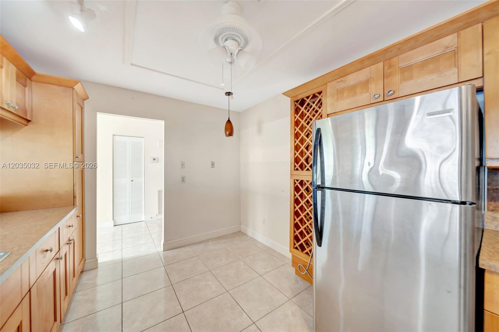 5223 Gate Lake Road, Unit 5223 Tamarac, FL 33319 - Photo 14 of 37 a view of a refrigerator in kitchen and an empty room