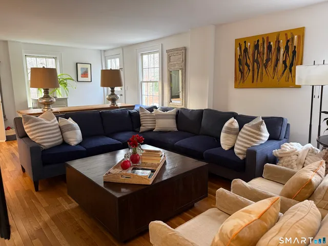 a living room with furniture rug and window