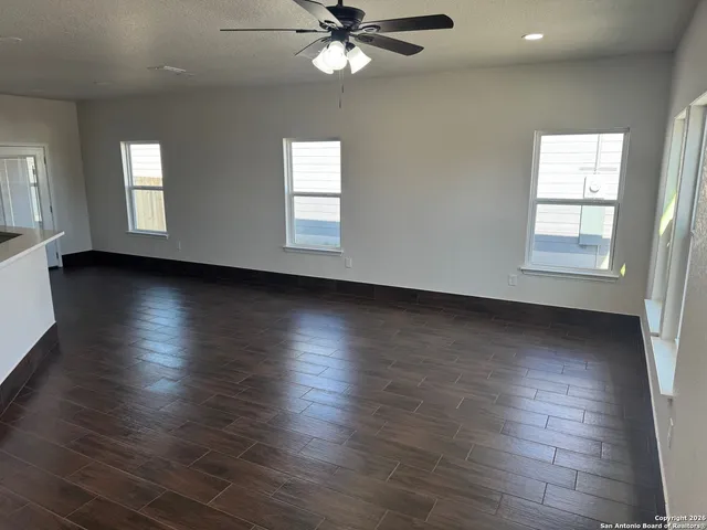 a view of a livingroom with wooden floor and a window