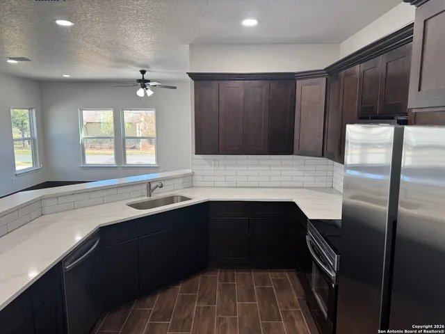 a kitchen with a sink and refrigerator