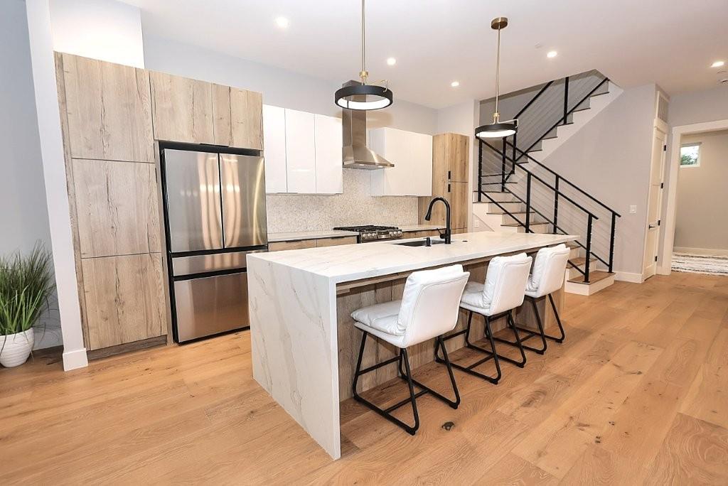 4014 Capitola Hills Court Fair Oaks, CA 95628 - Photo 13 of 59 a kitchen with stainless steel appliances kitchen island a table chairs in it and wooden floors