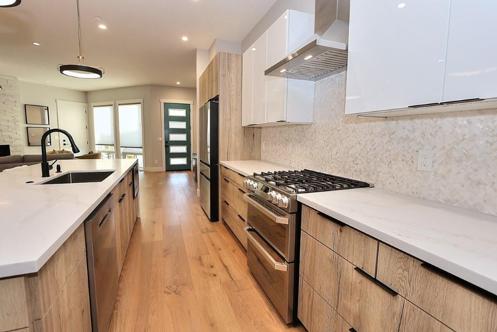 4014 Capitola Hills Court Fair Oaks, CA 95628 - Photo 16 of 59 a kitchen with kitchen island a sink stove and wooden floor