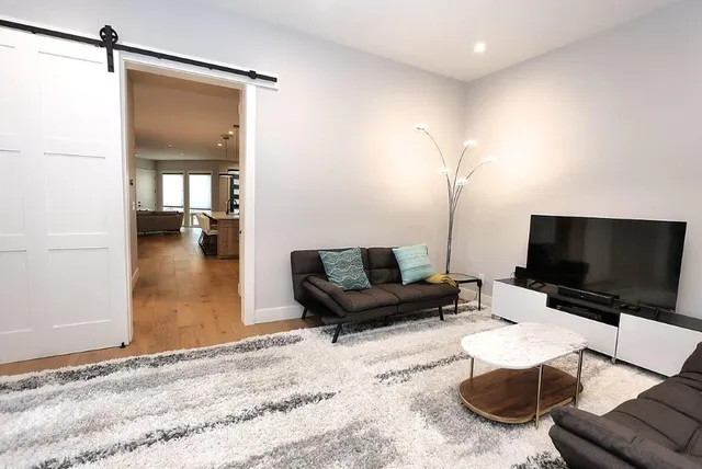 a bedroom with a bed and large window