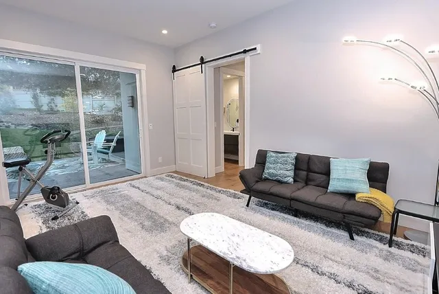 a bedroom with a bed and large window